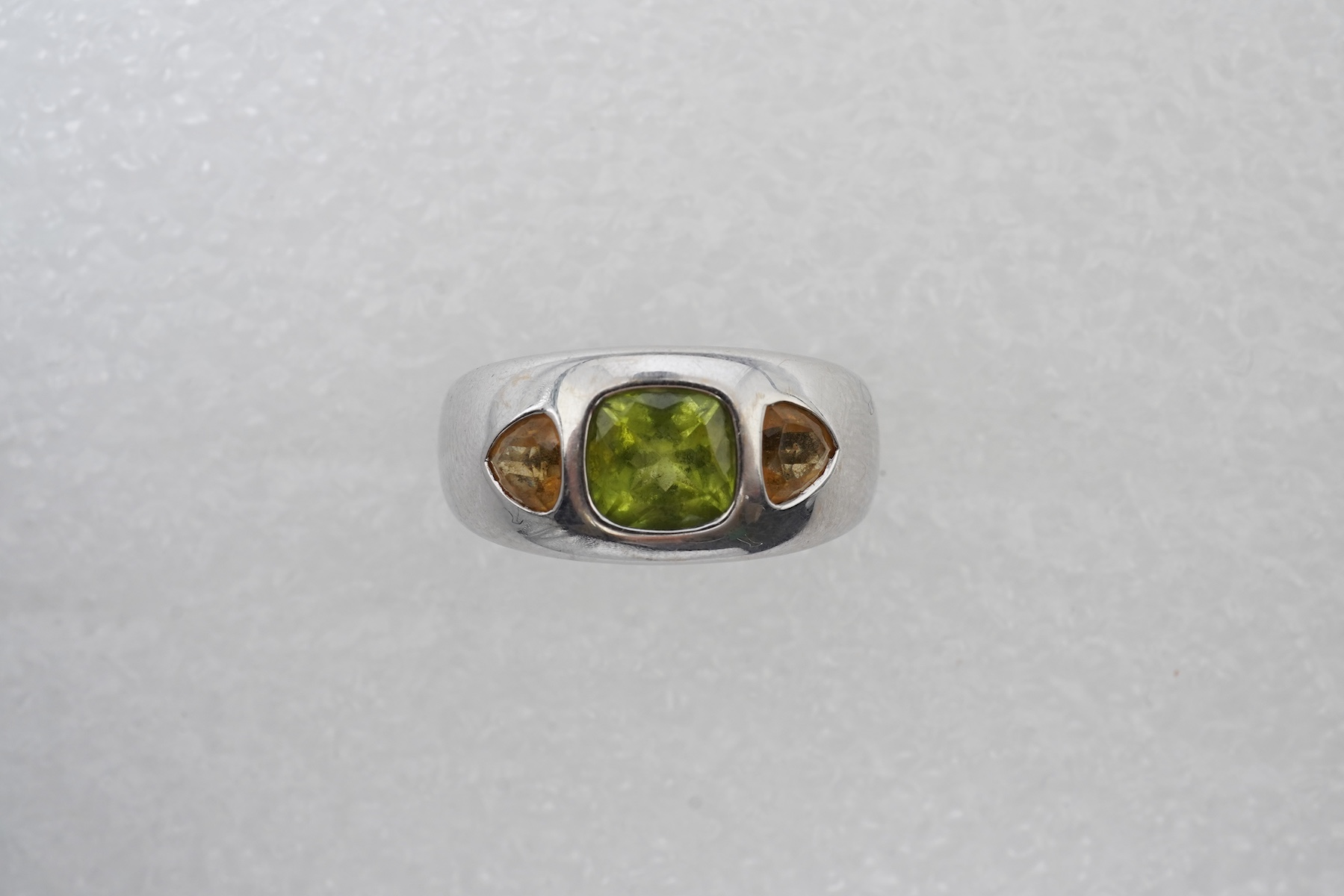 A peridot and citrine dress ring